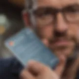 Person looking at their smartphone displaying insurance card details